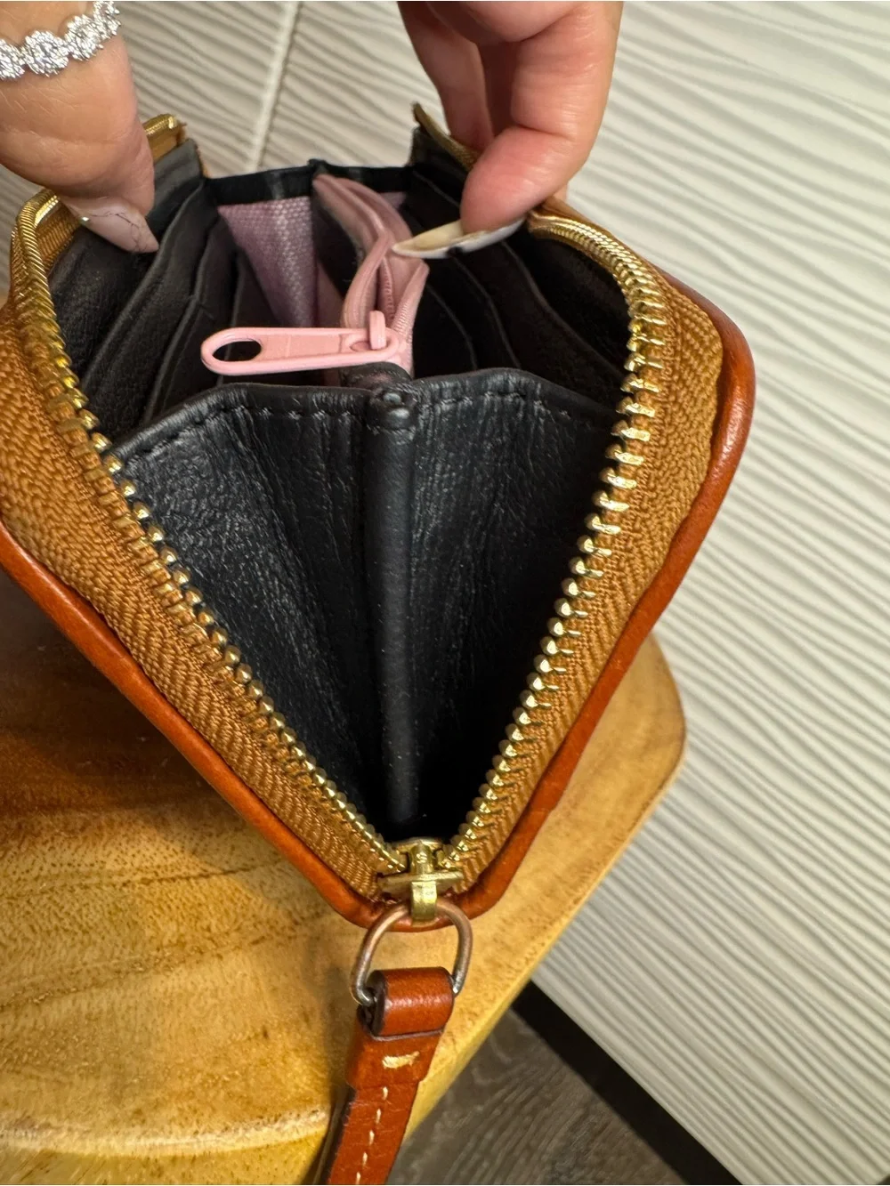 Dooney & Bourke Black Pebbled Leather Zip Wallet with Tan Trim and Logo Plate